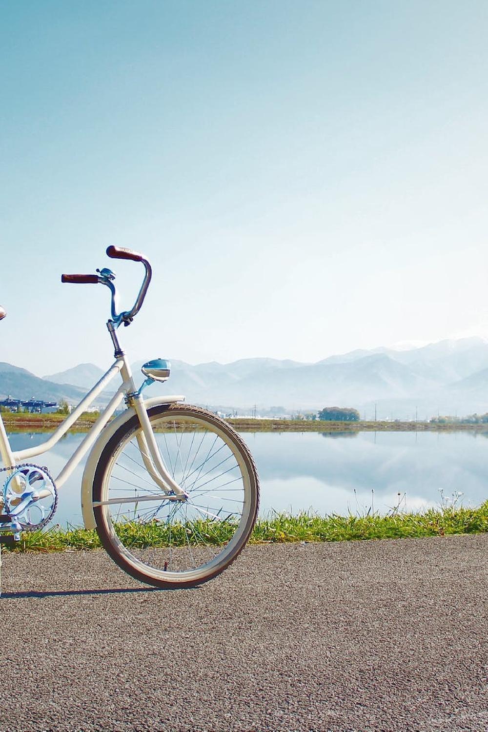  gray_commuter_bike_parked_on_road_beside_sea