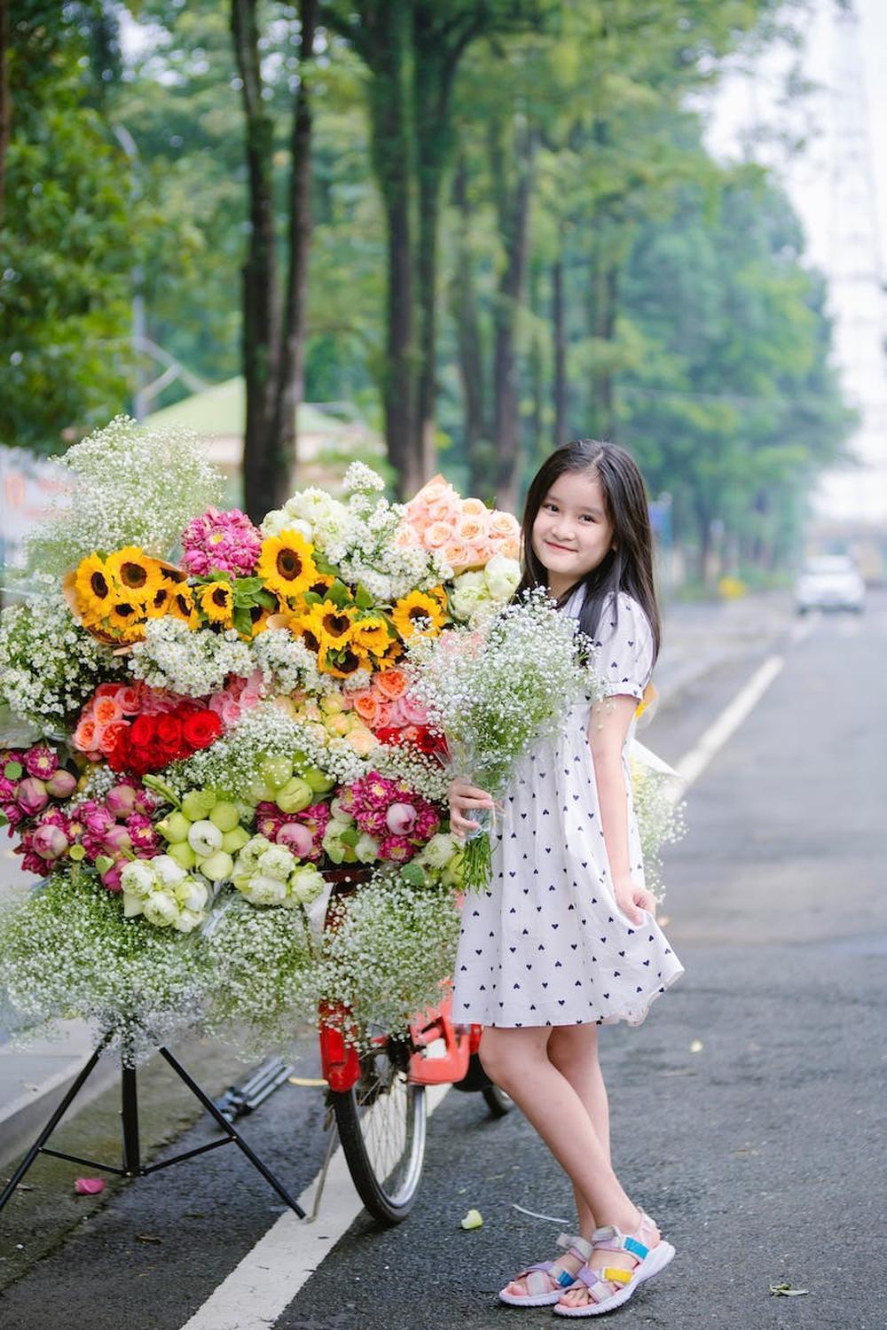  teenager_girl_posing_with_a_heap_of_flower_bouquet